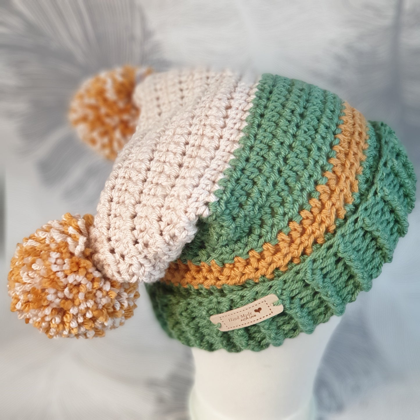 Crocheted double pompom corner hat