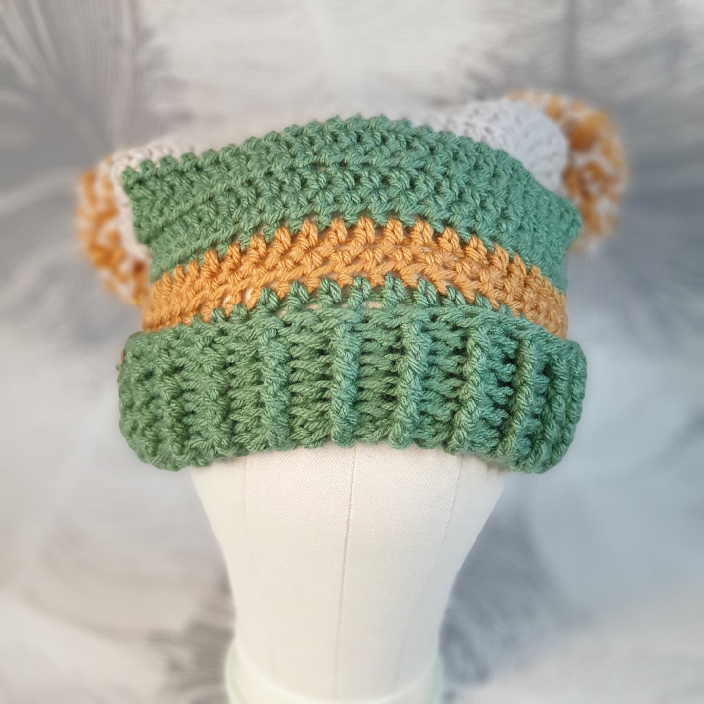 Crocheted double pompom corner hat